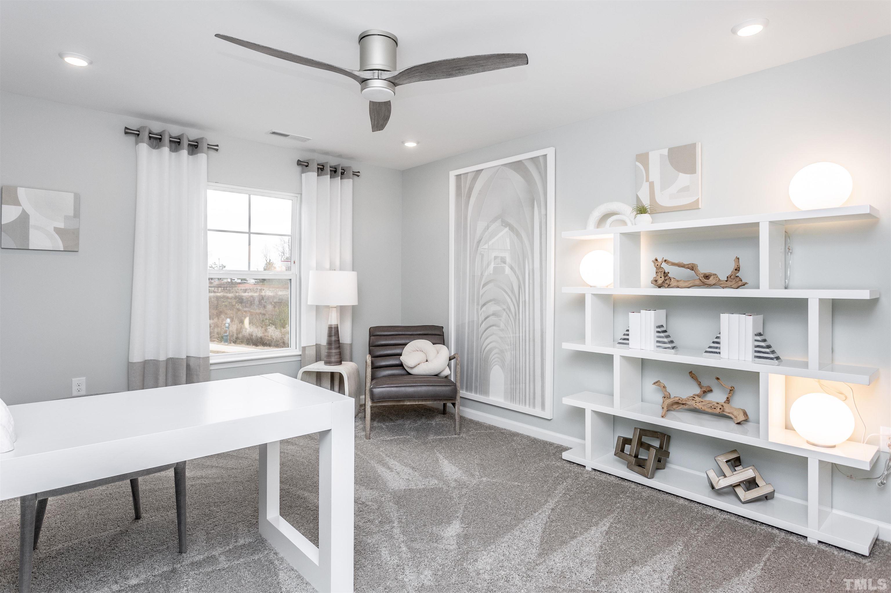 4906 Megara Run, Unit ROYAL Raleigh, NC 27603 - Photo 18 of 23 a living room with furniture a rug and a window