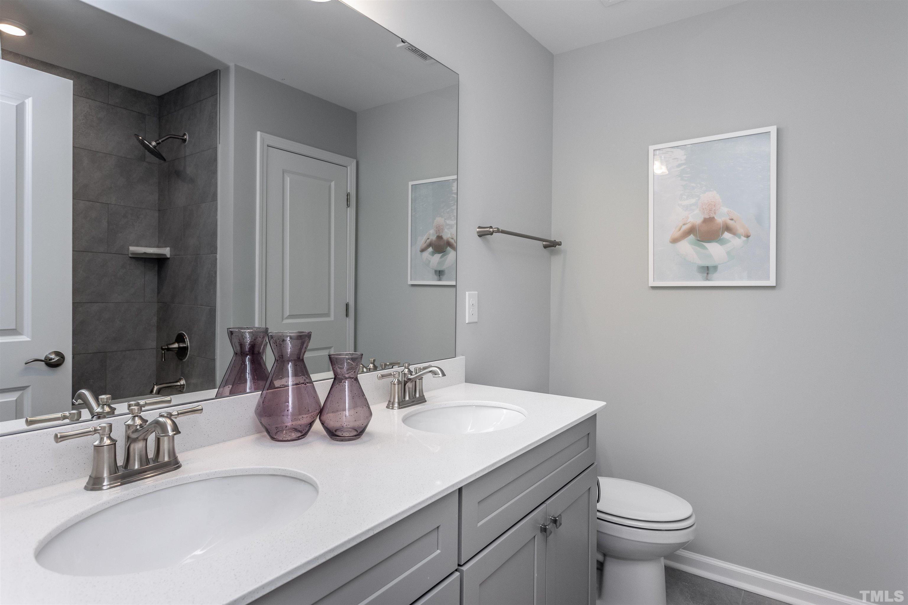 4906 Megara Run, Unit ROYAL Raleigh, NC 27603 - Photo 20 of 23 a bathroom with a sink a toilet and mirror