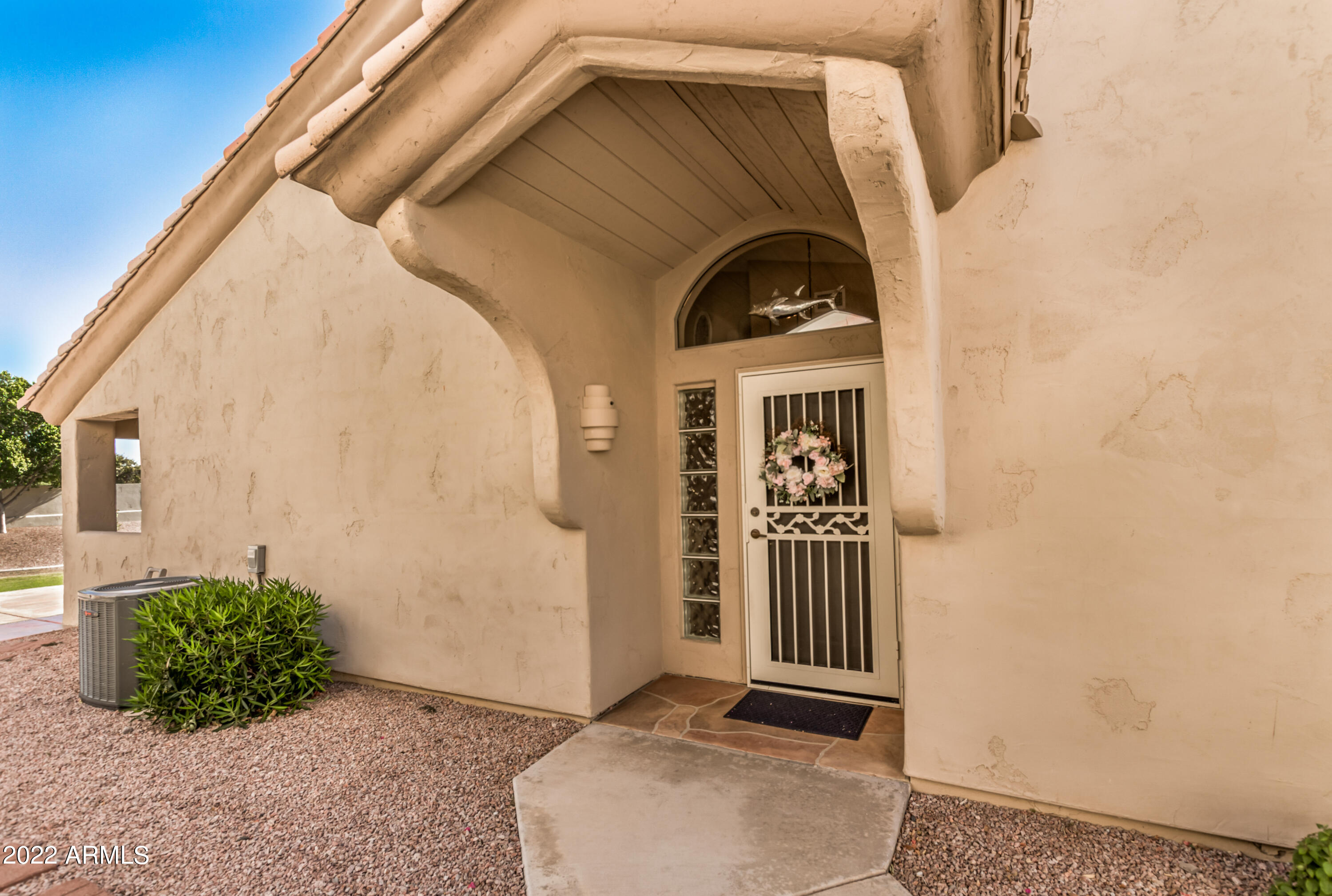 5830 East McKellips Road, Unit 76 Mesa, AZ 85215 - Photo 5 of 33 a front view of a house with a yard