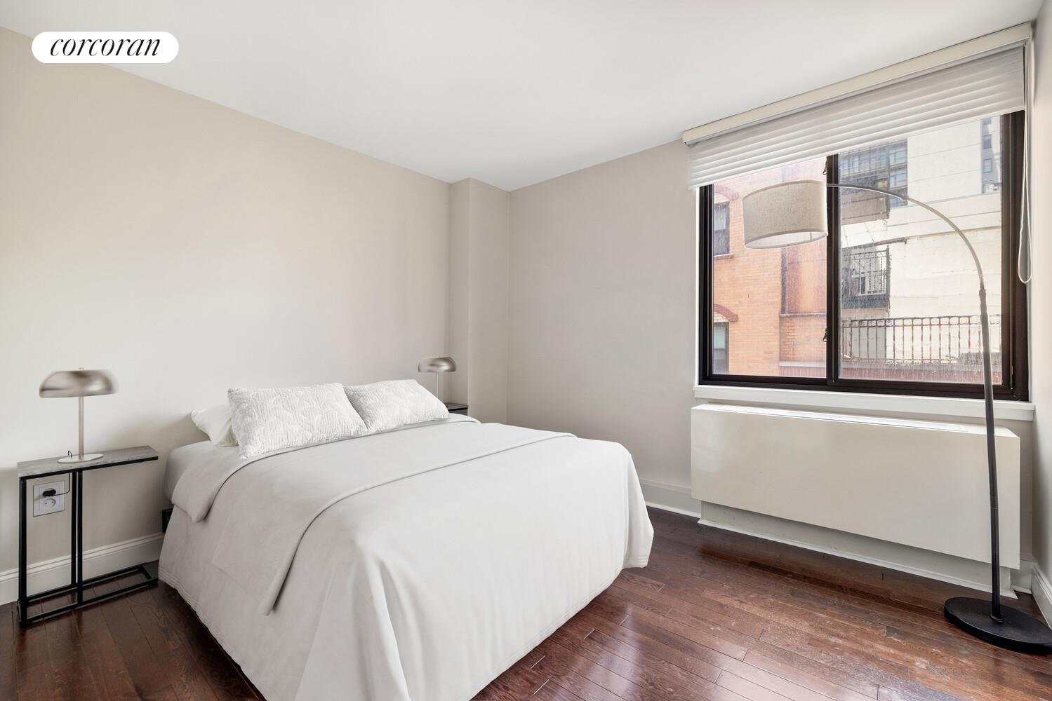 199 Bowery, Unit 5B Manhattan, NY 10002 - Photo 4 of 5 a bedroom with a bed and a large window