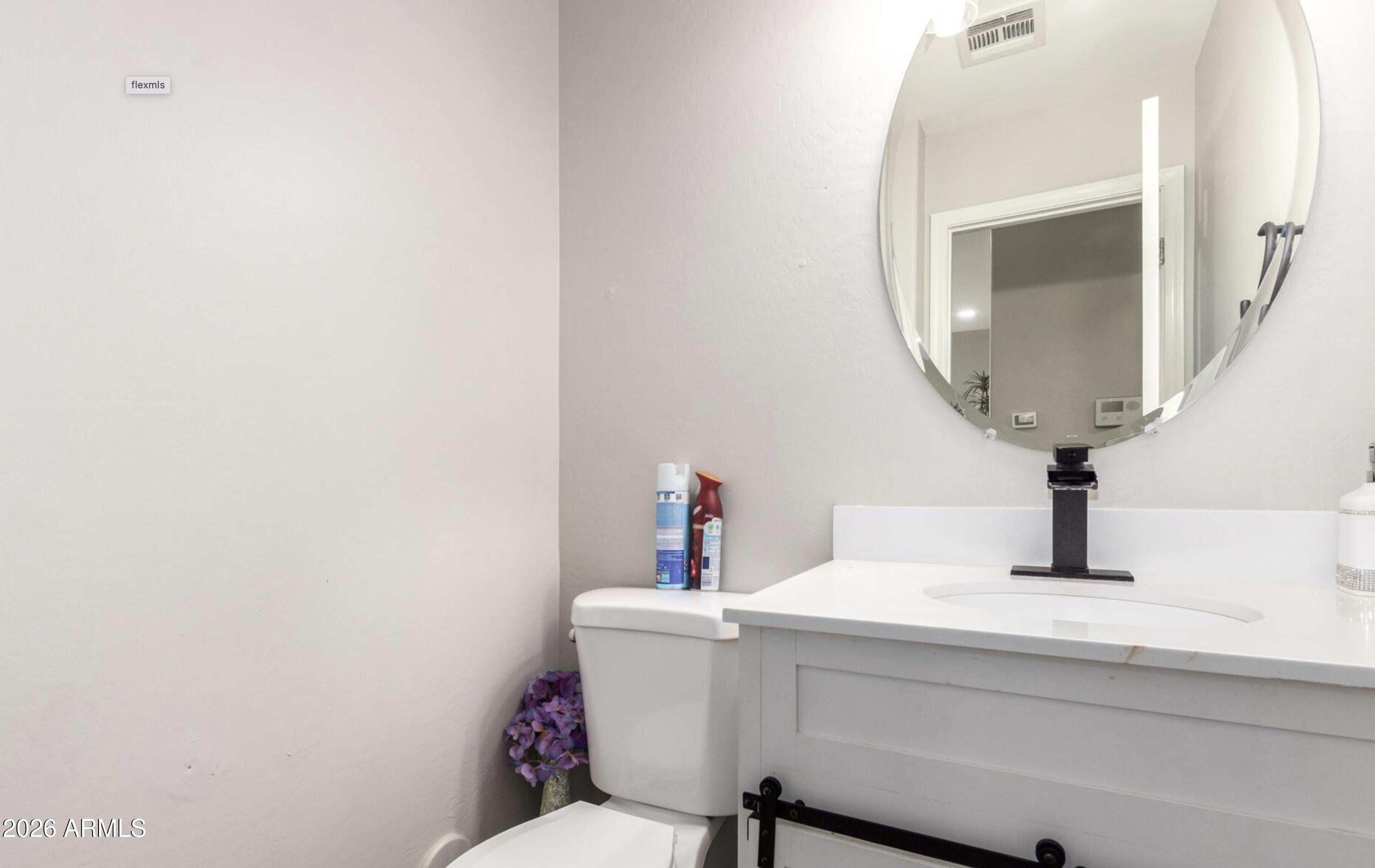 10225 West Camelback Road, Unit 12 Phoenix, AZ 85037 - Photo 14 of 19 a bathroom with a sink and a mirror