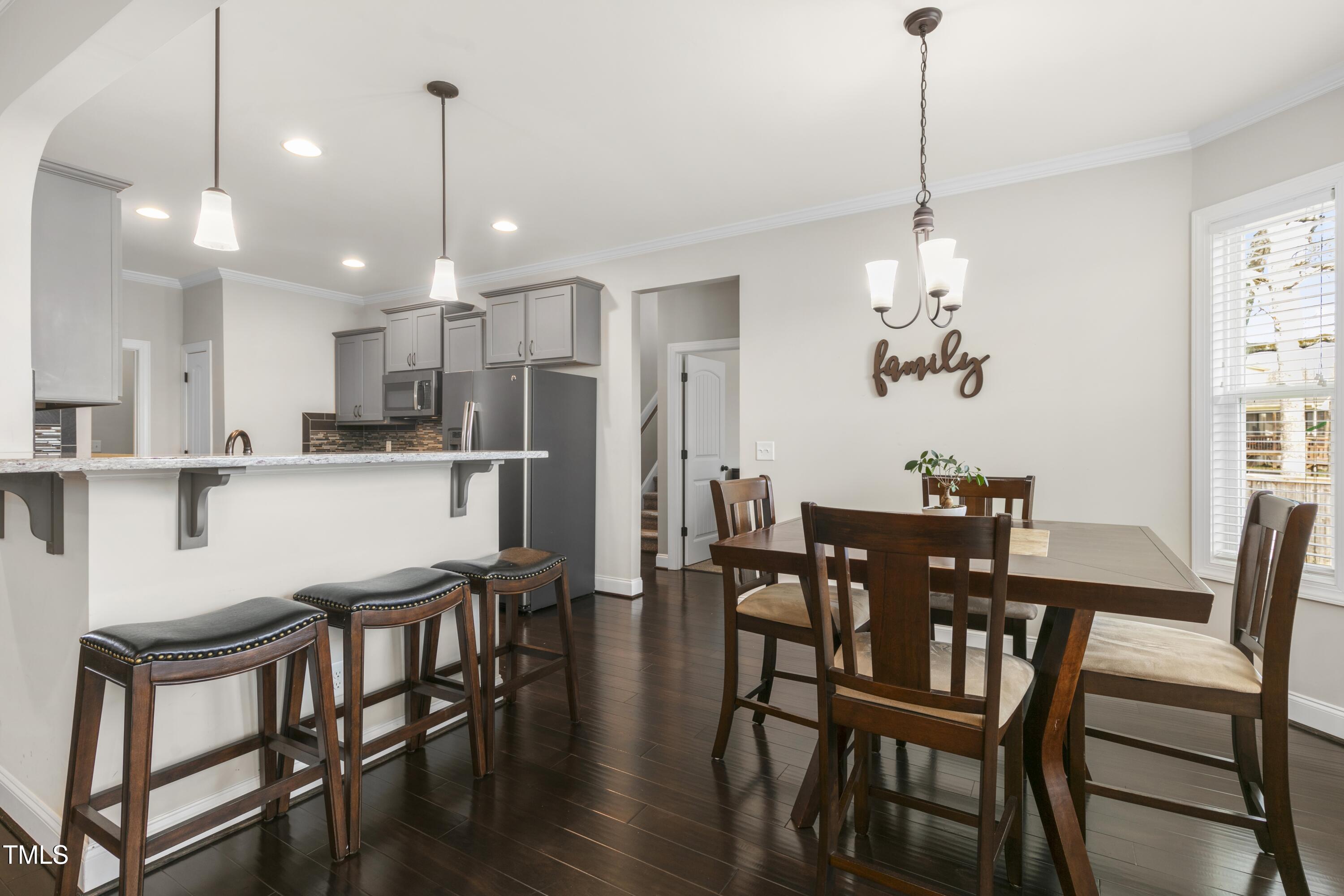 1044 Butterfly Circle Wake Forest, NC 27587 - Photo 10 of 46 a view of a dining room and livingroom with furniture wooden floor kitchen chandelier