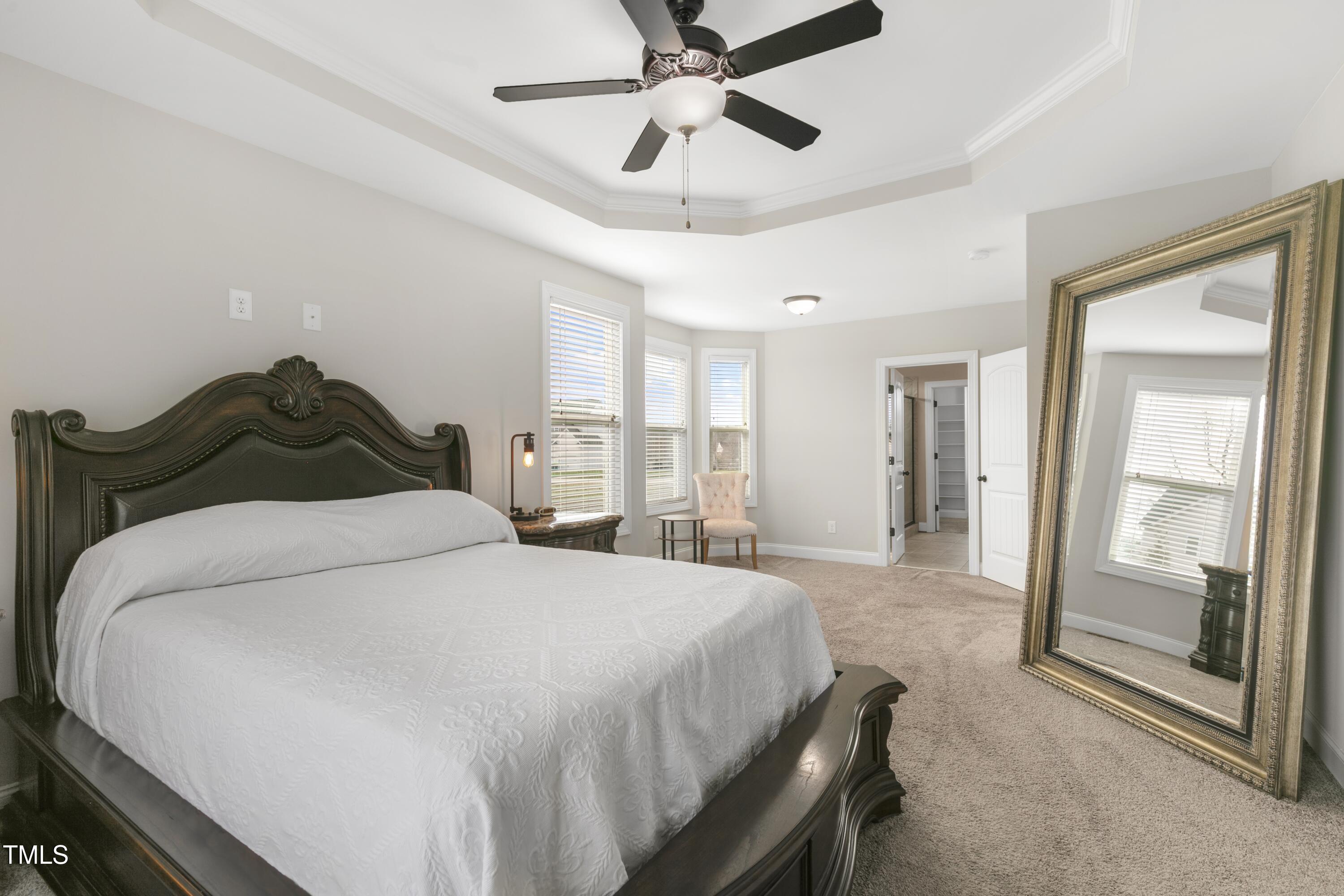 1044 Butterfly Circle Wake Forest, NC 27587 - Photo 15 of 46 a bedroom with a bed and large mirror