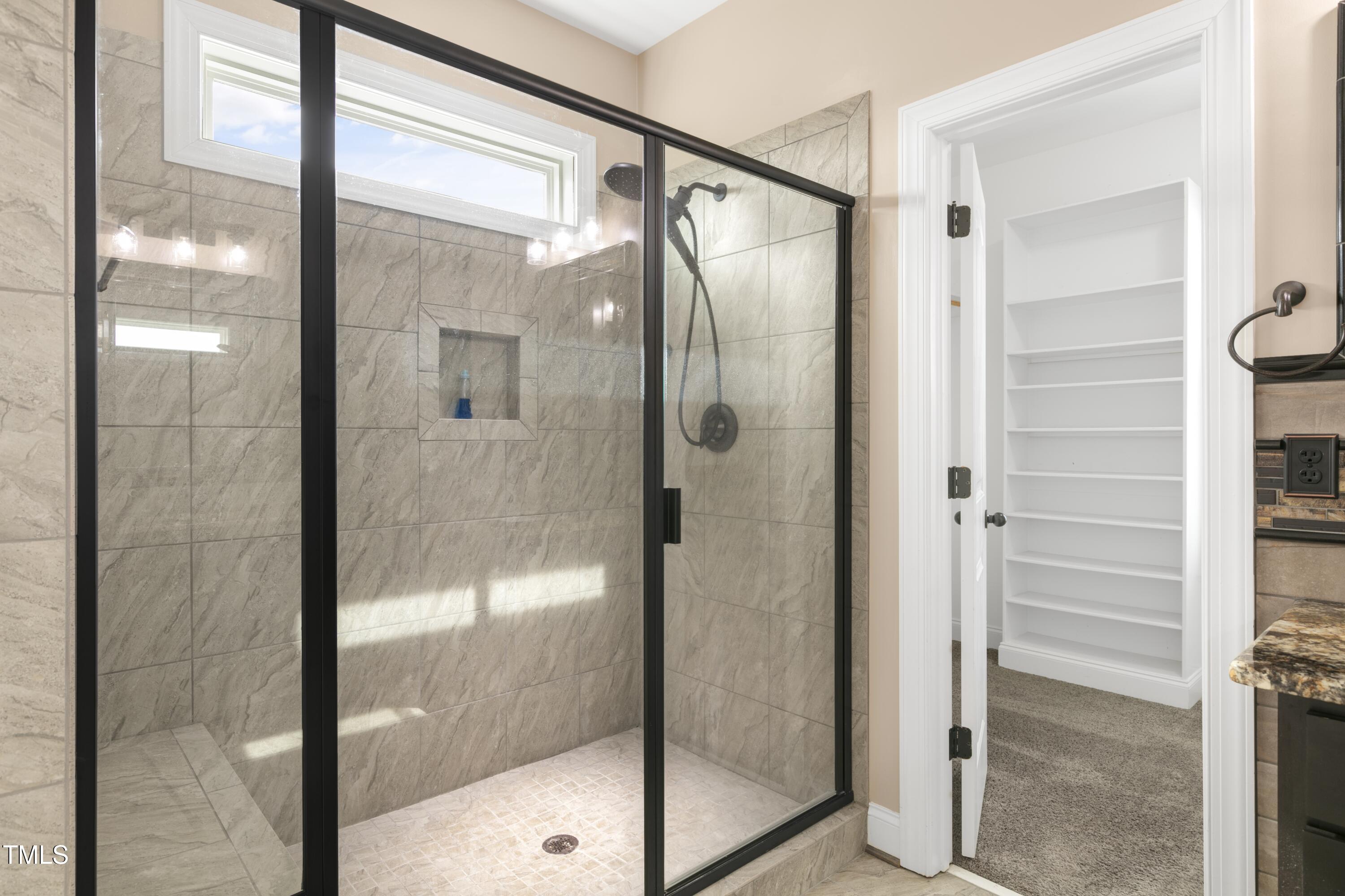 1044 Butterfly Circle Wake Forest, NC 27587 - Photo 31 of 46 a bathroom with a glass shower door