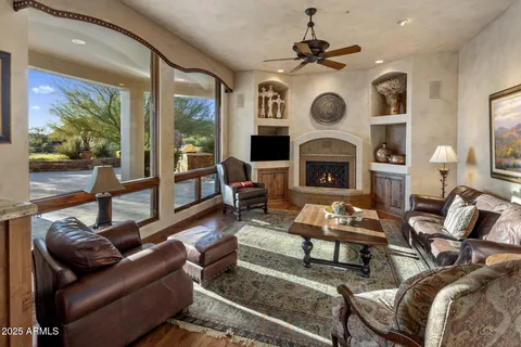 a living room with furniture and a floor to ceiling window