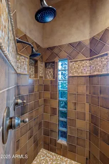 a bathroom with a granite countertop sink a large mirror and a shower