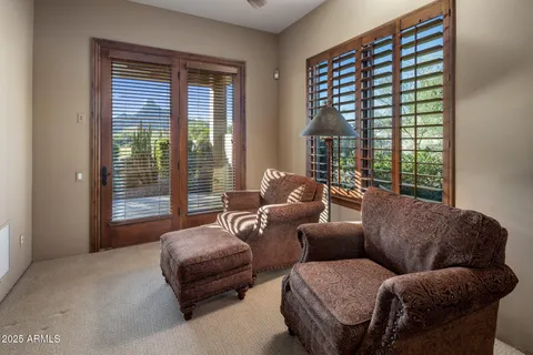 a bedroom with a large bed couch and a window
