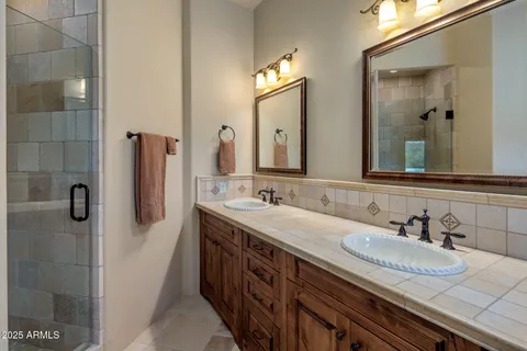 a bathroom with a tub sink and mirror