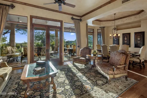 a living room with furniture and large windows