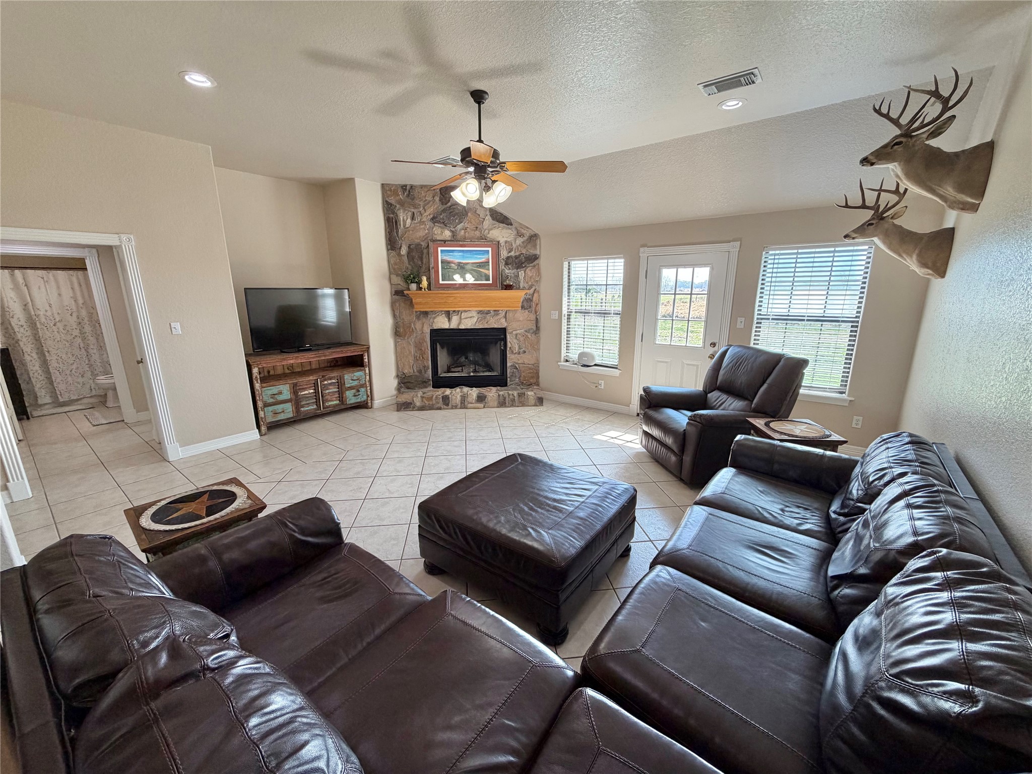 15903 County Road 621 Angleton, TX 77515 - Photo 8 of 33 a living room with furniture a fireplace and a flat screen tv