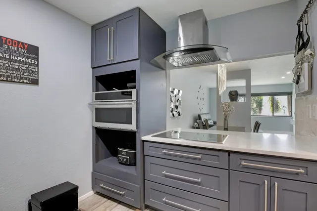 a en suite bathroom with a granite countertop sink and a mirror