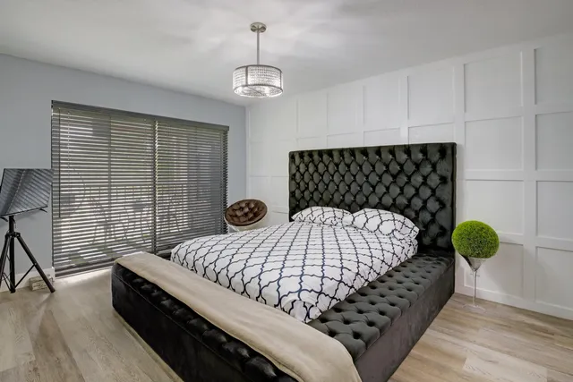 a bedroom with bed and window