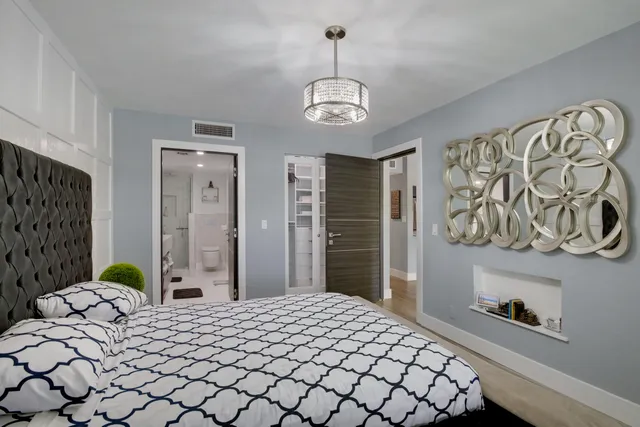 a bedroom with a bed dresser and a window