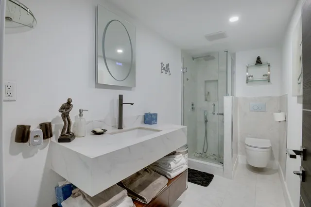 a bathroom with a glass shower door