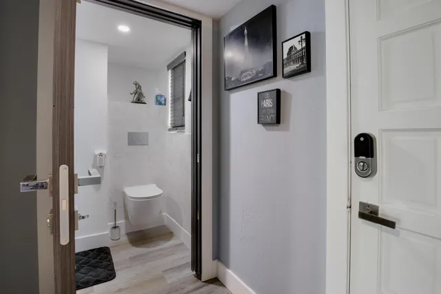 a white toilet sitting next to a bathroom sink
