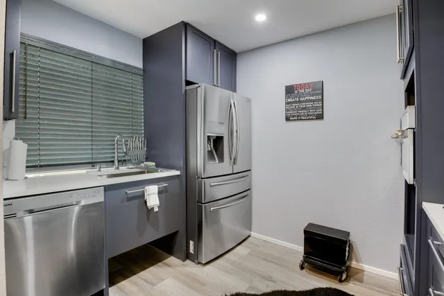 a kitchen with stainless steel appliances a refrigerator and a sink