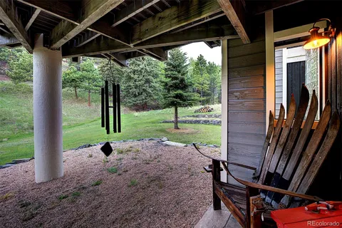 a view of a backyard with floor to ceiling window and wooden floor