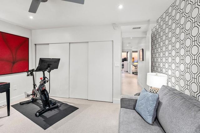 a living room with furniture a air conditioner and a window