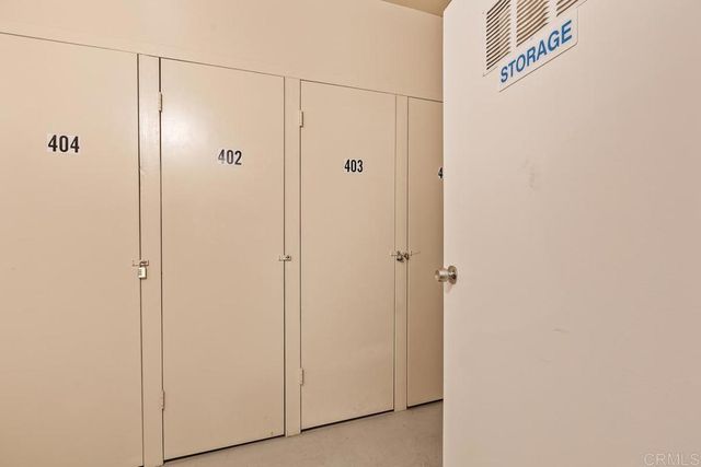 a living room with furniture a chandelier and a flat screen tv