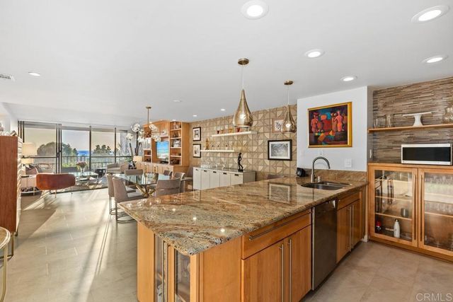 a kitchen with stainless steel appliances granite countertop a sink and cabinets