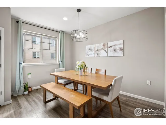 a view of a dining room with furniture wooden floor and a chandelier