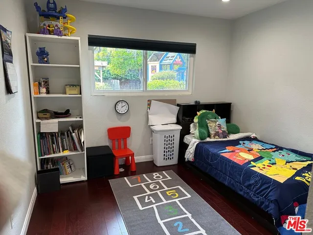 a bedroom with furniture and a book shelf