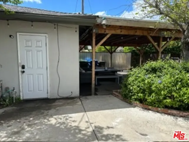 a view of a chair and table in front of house