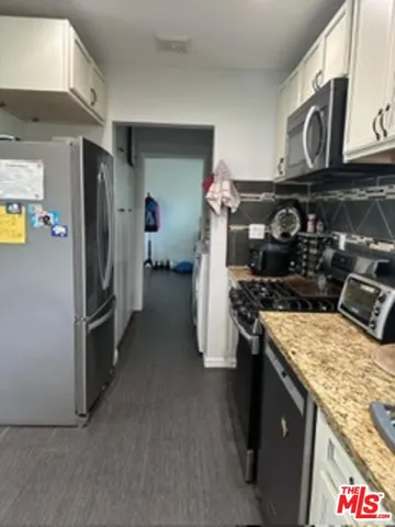a kitchen with a stove and a refrigerator