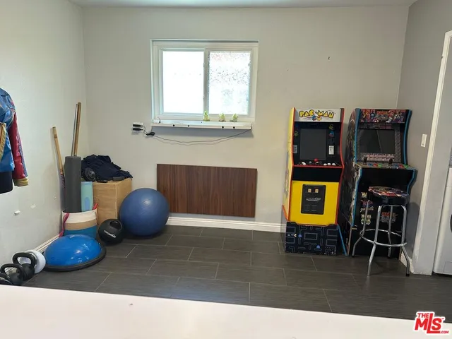 a view of a workspace with furniture and wooden floor
