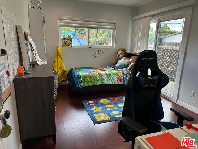 a bedroom with a bed closet and window