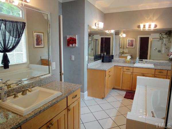 8016 Millenium Drive Raleigh, NC 27614 - Photo 10 of 25 Master bath with vaulted ceiling, granite countertops, dual vanities, tile floor, separate shower, and jetted tub.