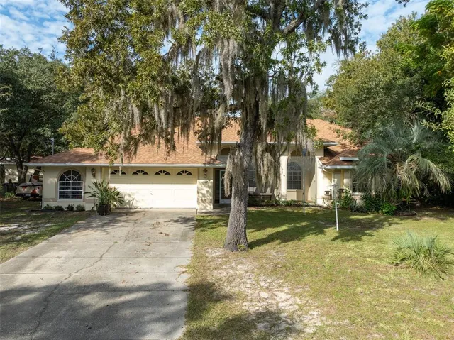 a view of a house with trees in the background