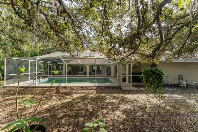 a view of a yard with large trees