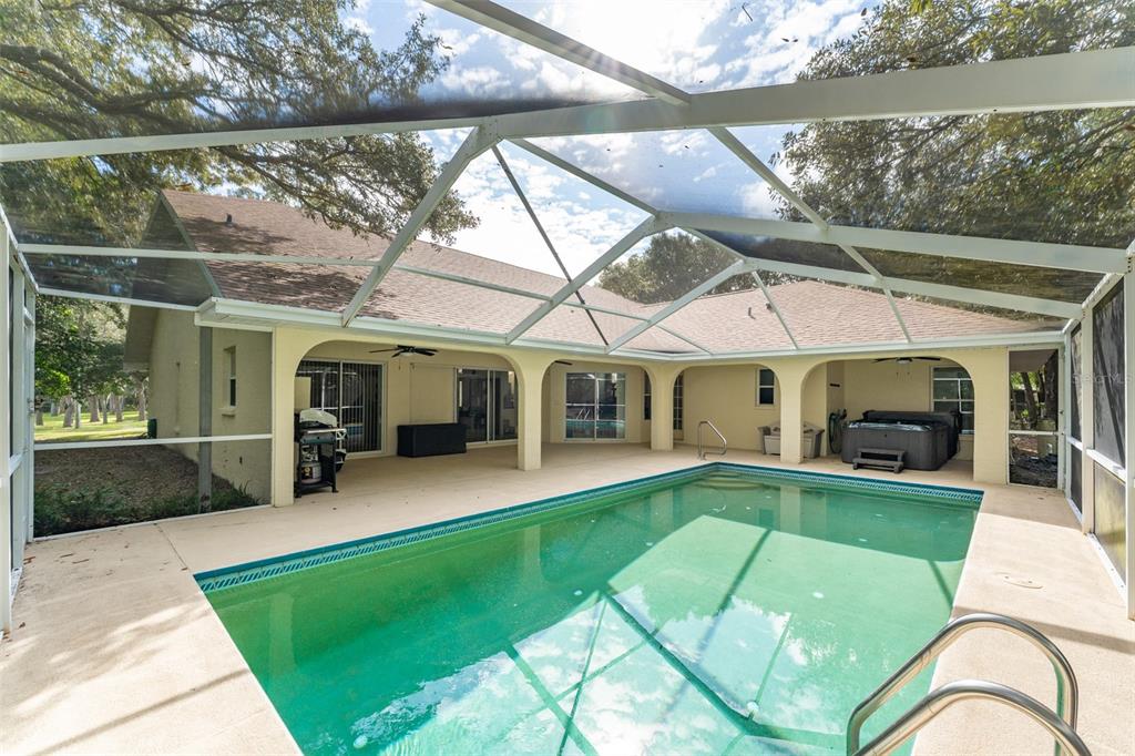5142 South Louise Point Homosassa, FL 34446 - Photo 27 of 55 a view of a white house with a big yard potted plants and a table