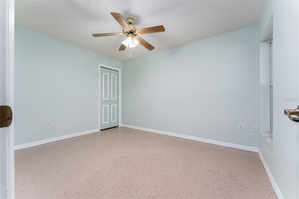 5142 South Louise Point Homosassa, FL 34446 - Photo 36 of 55 an empty room with windows and fan