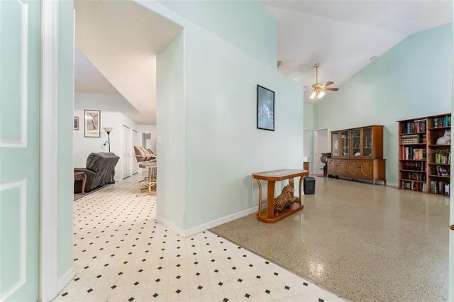 a living room with furniture a chandelier and a rug