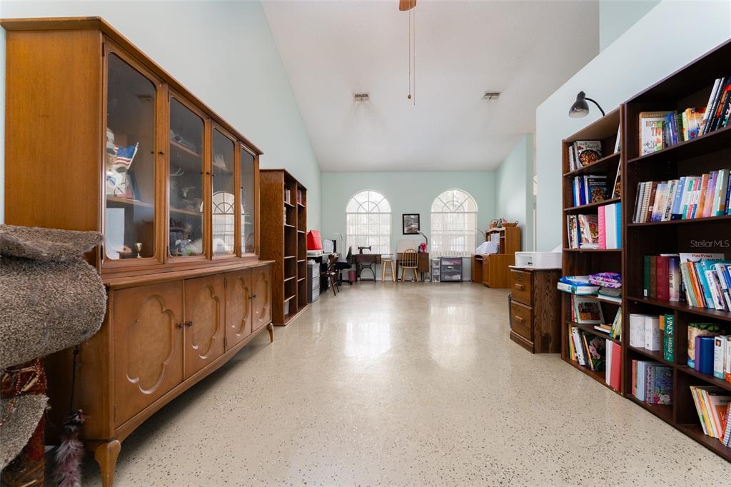 5142 South Louise Point Homosassa, FL 34446 - Photo 47 of 55 a living room with lots of furniture and a book shelf