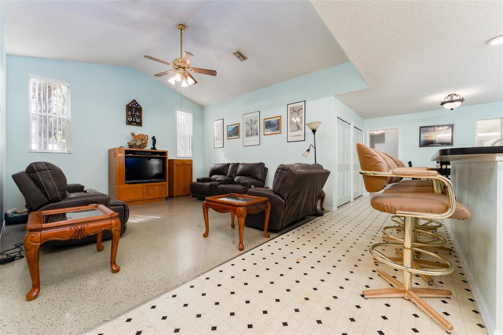 5142 South Louise Point Homosassa, FL 34446 - Photo 48 of 55 a living room with furniture a chandelier and a rug