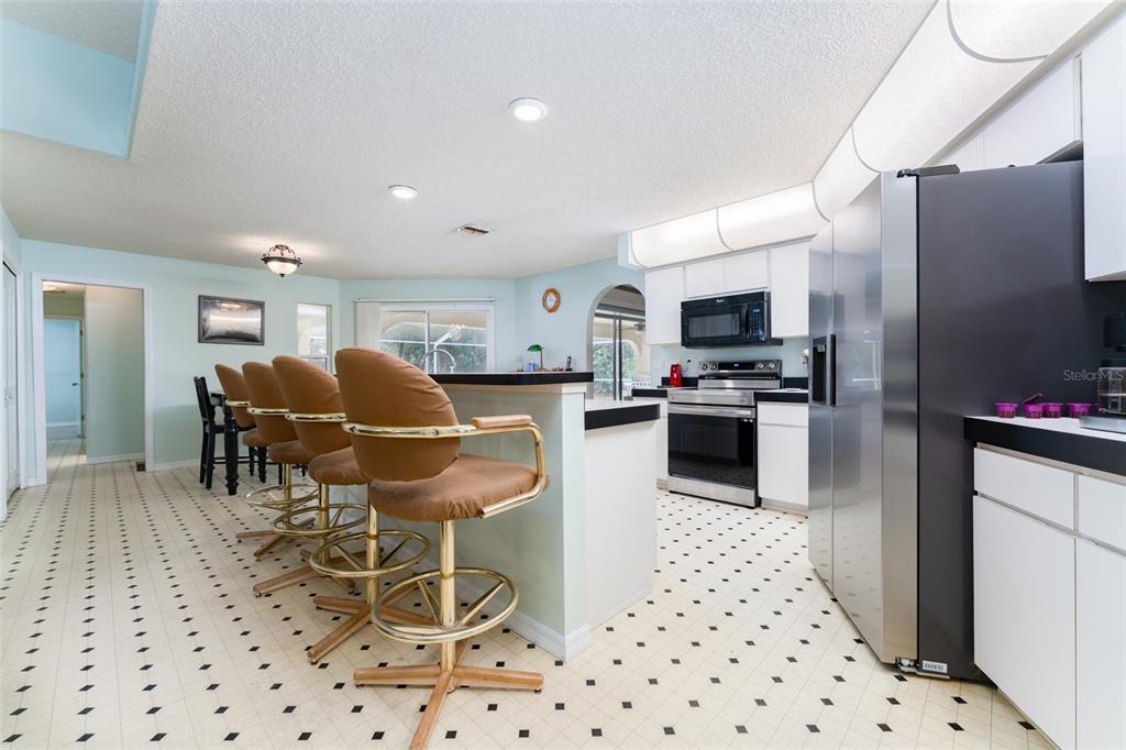 5142 South Louise Point Homosassa, FL 34446 - Photo 52 of 55 a kitchen with stainless steel appliances kitchen island granite countertop a refrigerator and a sink