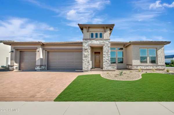 a front view of a house with a garden and plants