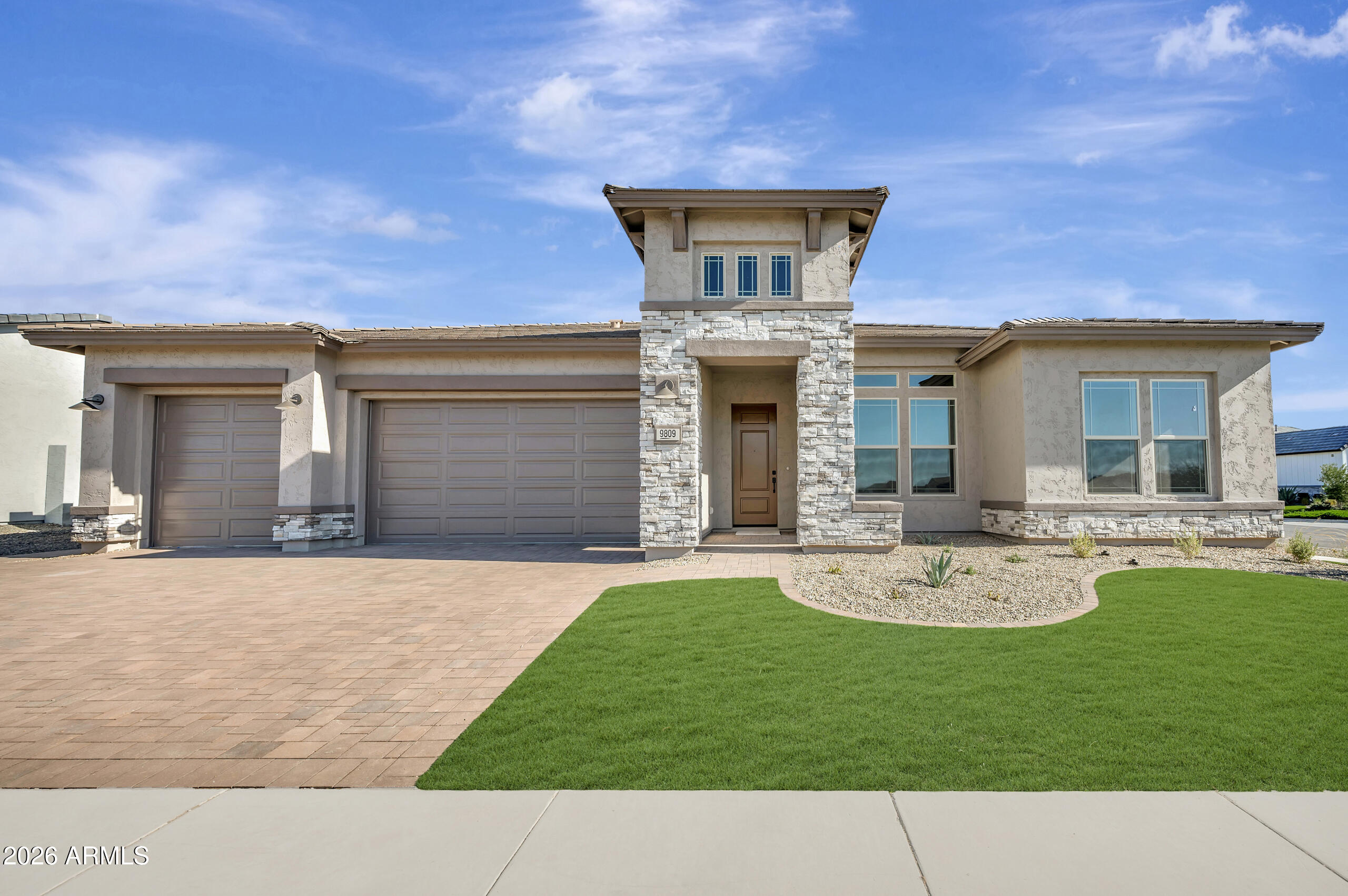 a front view of a house with a garden and plants