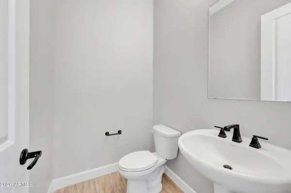 a bathroom with a sink a toilet and mirror