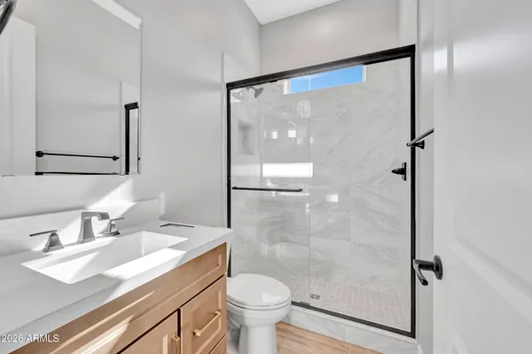 a bathroom with a sink toilet and shower