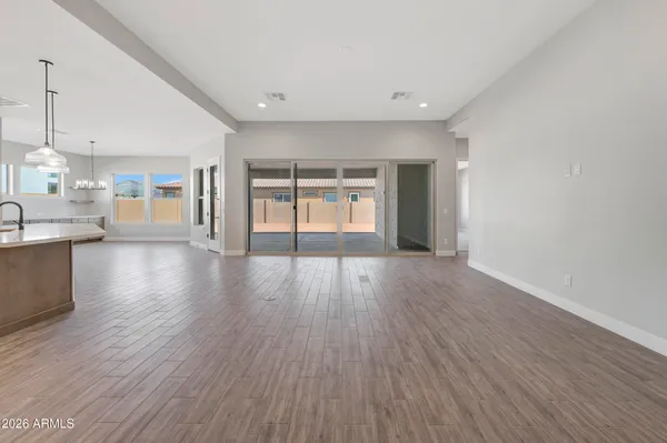 a view of an empty room and wooden floor