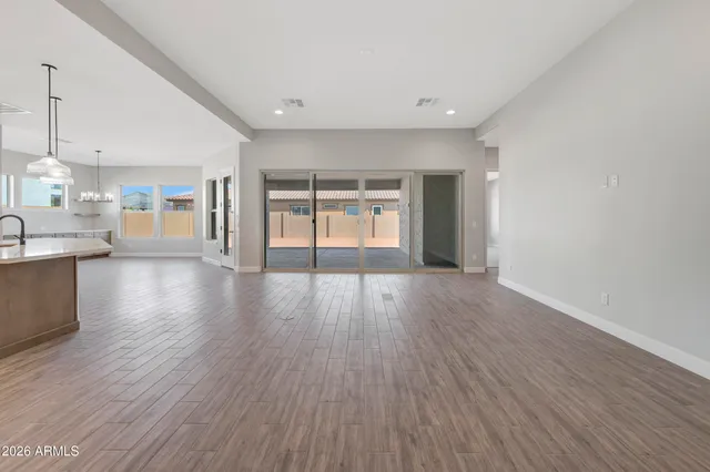 a view of an empty room and wooden floor