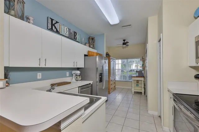 a kitchen with a refrigerator and cabinets