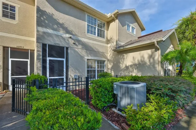 a view of a house with brick walls and a flower garden