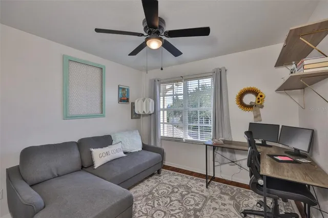 a living room with furniture and a lamp