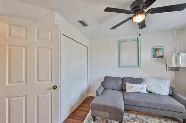 a view of a hallway with workspace and mirror with wooden floor