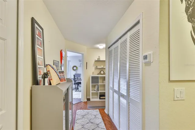 a hallway with a sink and a mirror